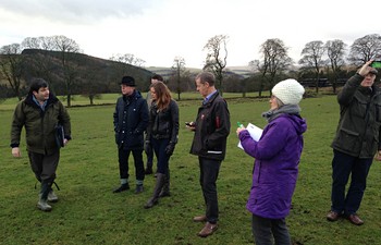 Derek Robeson, left, of the Tweed Forum, an NGO that is working with local landowners, shows the Swedish delegation around Crookston Farm in the Scottish Borders. 