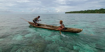 Two fishermen put out a net to catch reef fish in Fumato’o, Malaita Province, Solomon Islands. 
