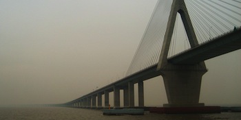 A long bridge over foggy water