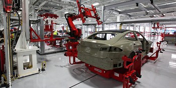 An electric car is assembled at a Tesla manufacturing plant