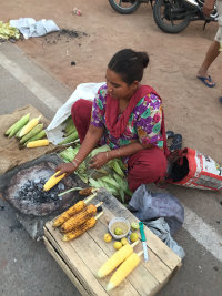 A street vendor grills maize for sale near the conference facility. Photo credit: Albert Salamanca, SEI.