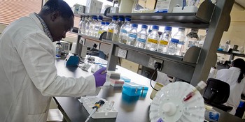 Scientists work in a laboratory at the International Livestock Research Institute in Nairobi, Kenya