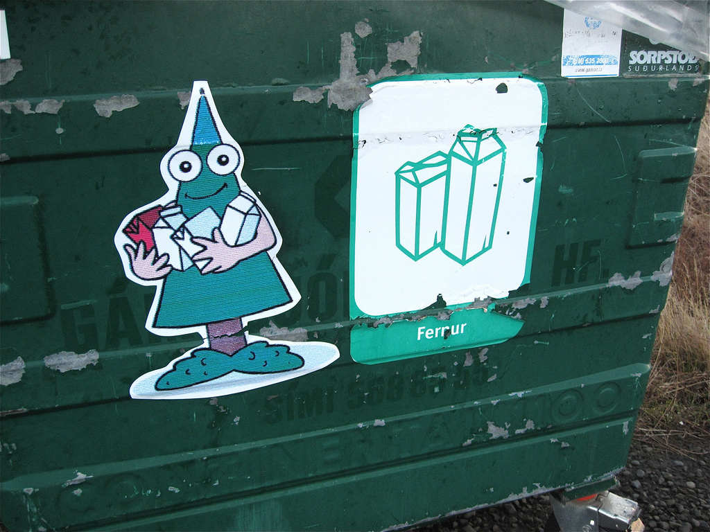 Side of recycling bin with cartoonish stickers