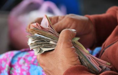 Woman sitting with cash in her hands