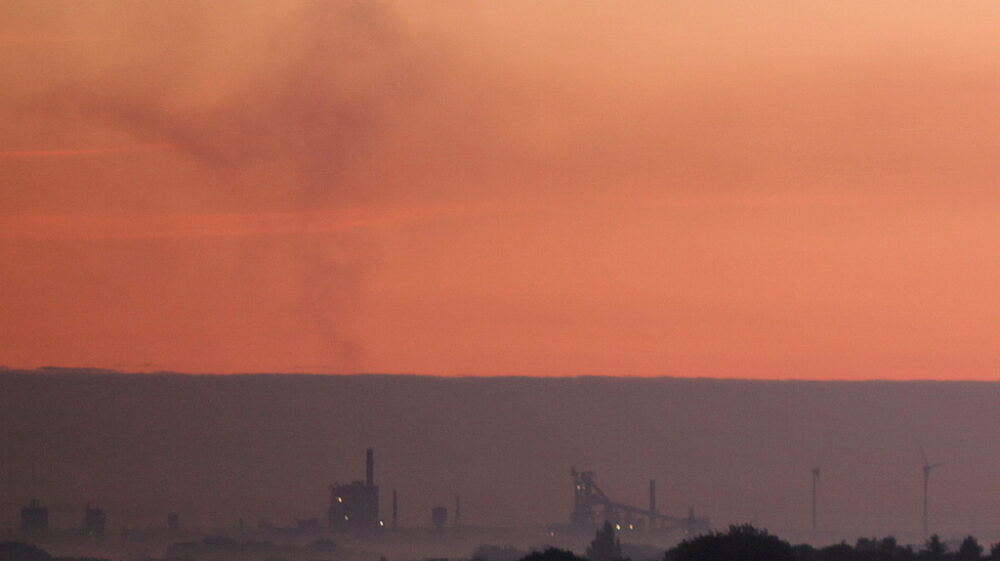 Air pollution from factory in sunset