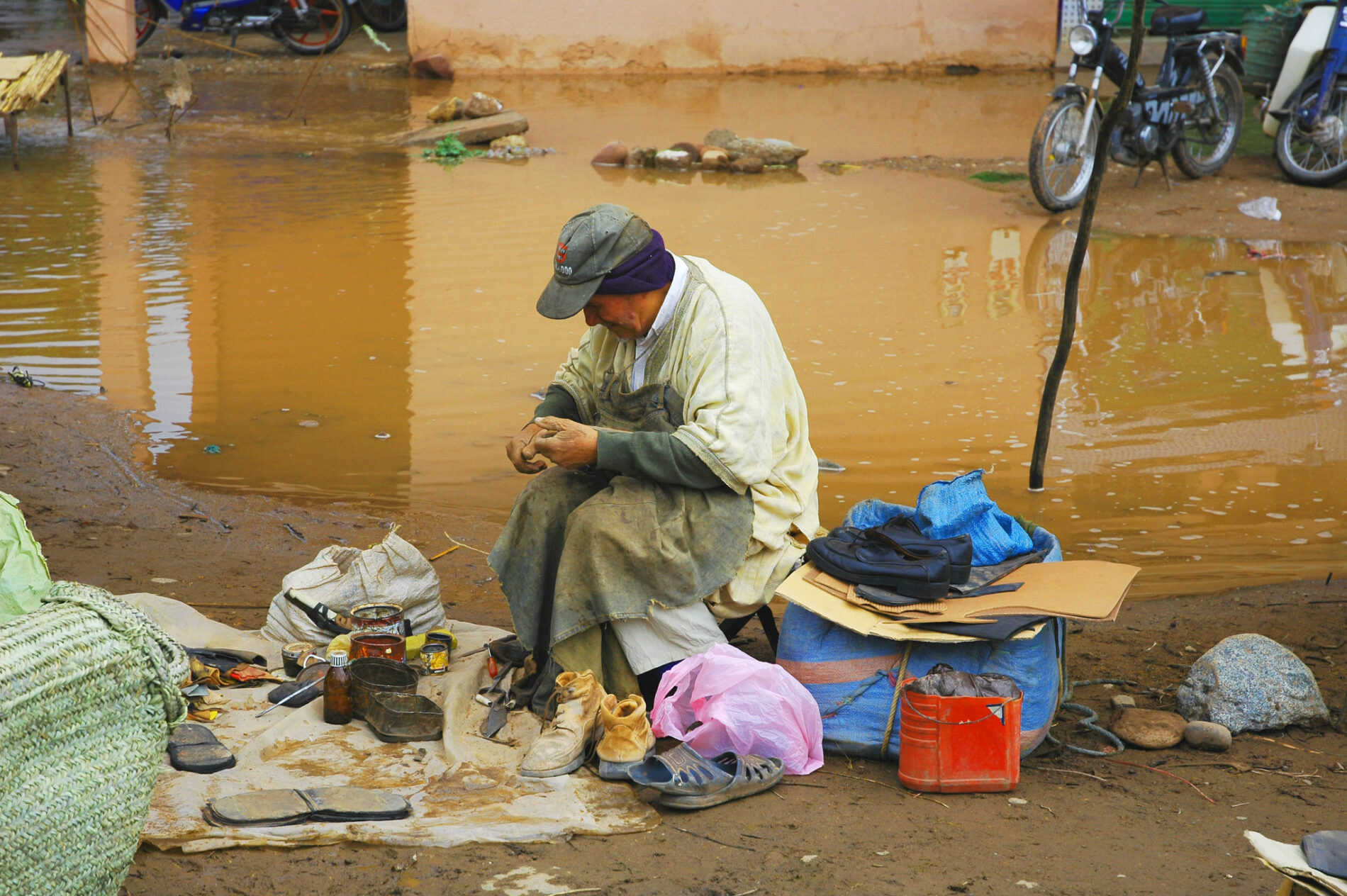 Person sits working on a task surrounded by objects