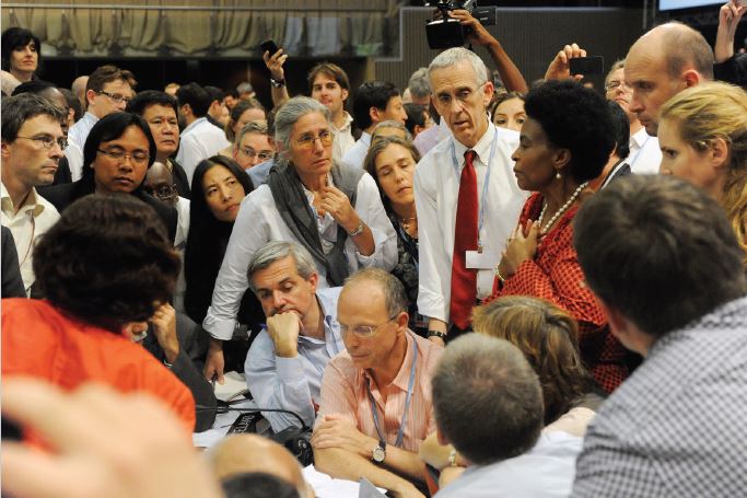 Negotiators huddle together to work out the final details