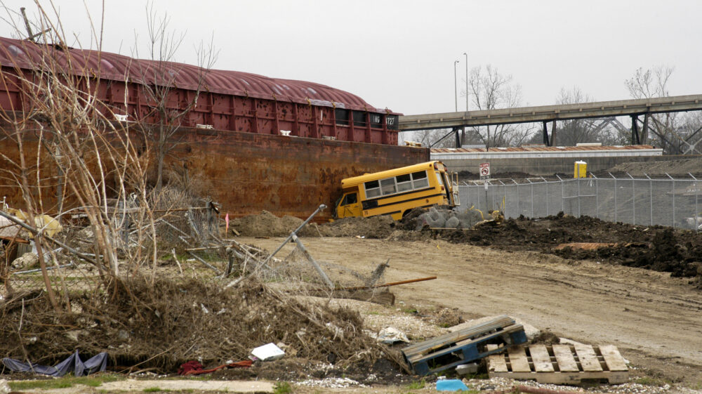 New Orleans parking lot after Hurricane Katrina; crashed bus, trash thrown around by storm