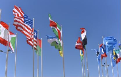 Flags blowing in the wind against a blue sky