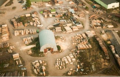 Birdview over field with stacked timber