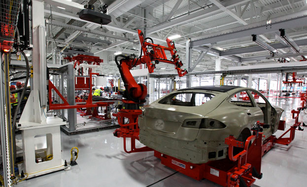An electric car is assembled at a Tesla manufacturing plant