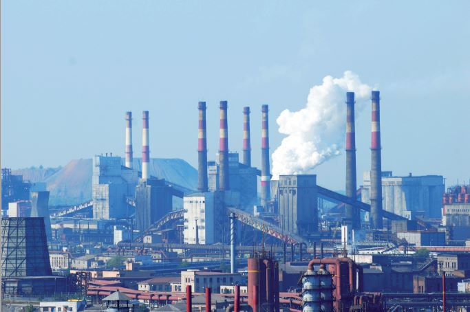 Factories with smoke coming out of chimneys