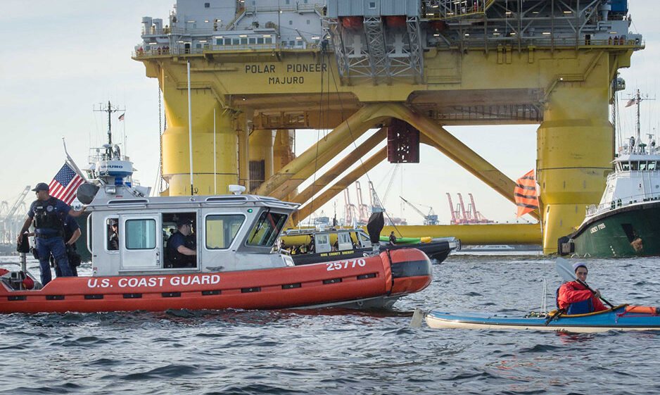 The U.S. Coast Guard provides a buffer between a 'kayaktivist' and Shell's Polar Pioneer oil rig