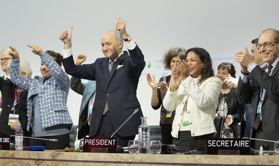 Cheers from the stage upon the adoption of the Paris Agreement at COP21