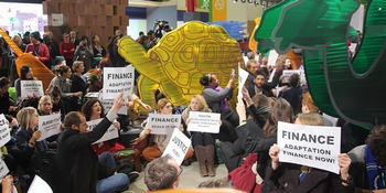 A civil society sit-in demanding climate justice outside the COP21 plenary rooms.