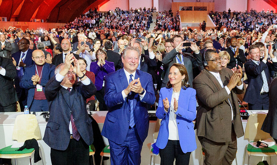 The audience erupts in applause upon the approval of the Paris Agreemen