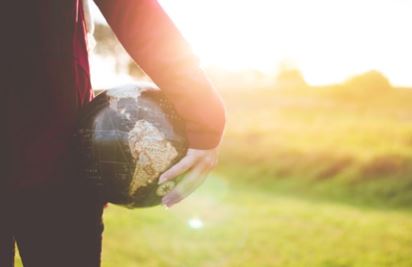 A woman holding a globe