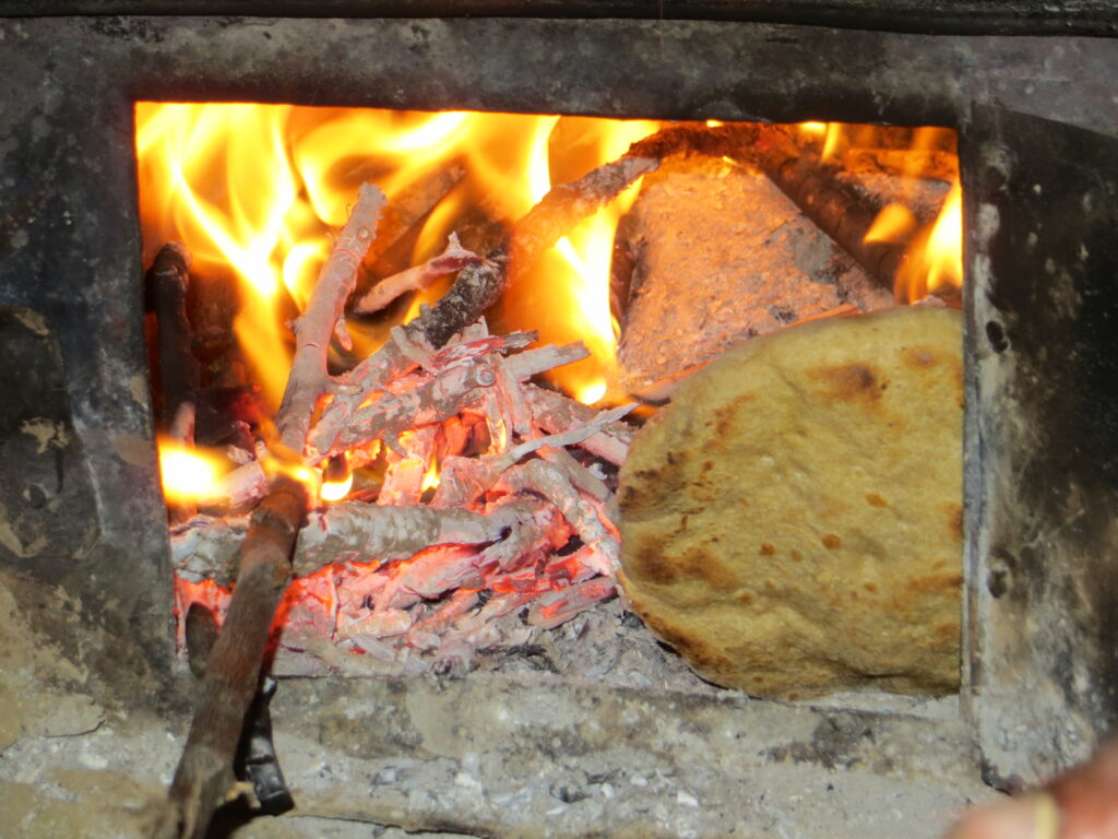 Roti cooking on an open fire