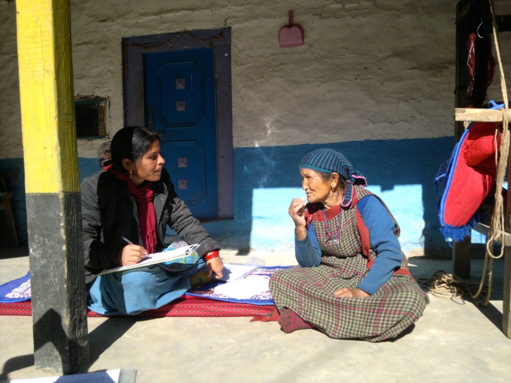 A researcher interviewing an elderly woman