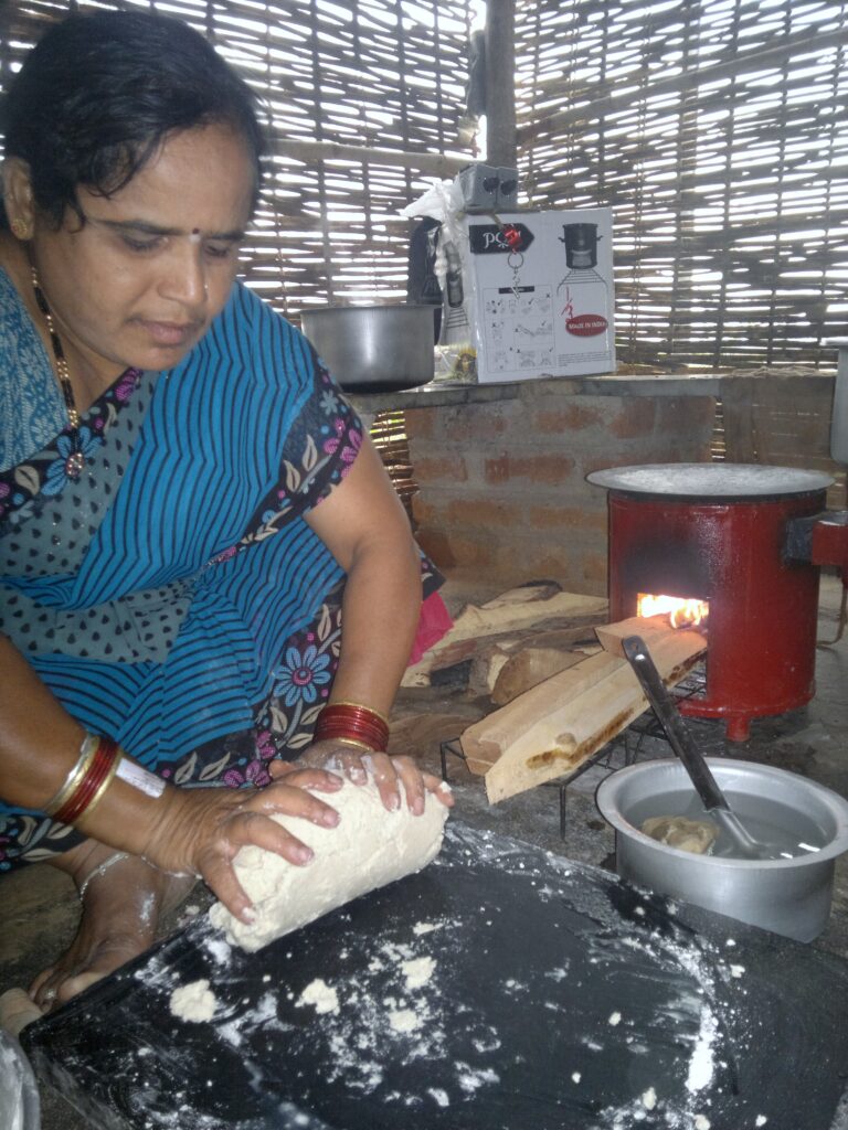 A woman preparing roti to cook