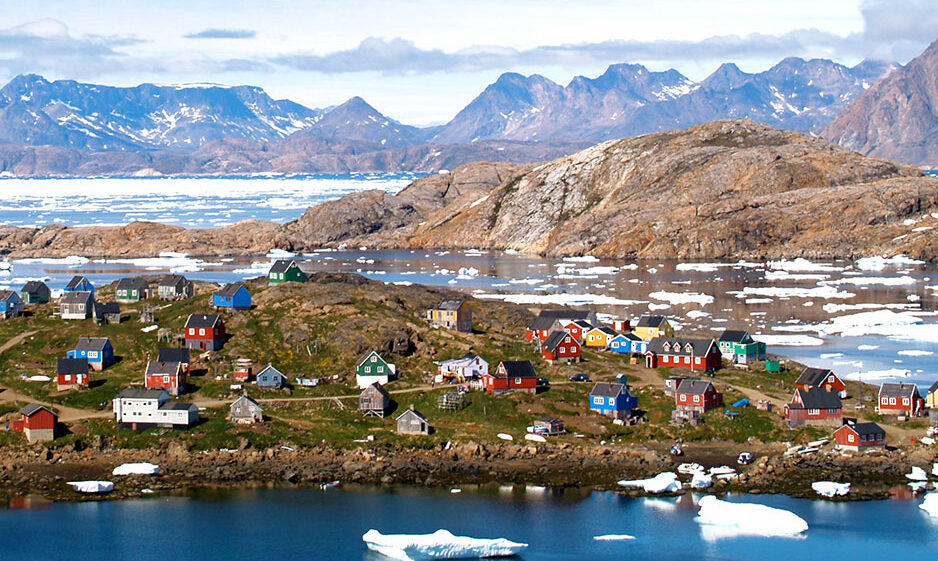 A village of coloured houses in an icy Arctic landscape.