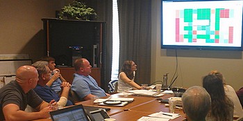 Laura Forni (at front of table) presents a data visualization