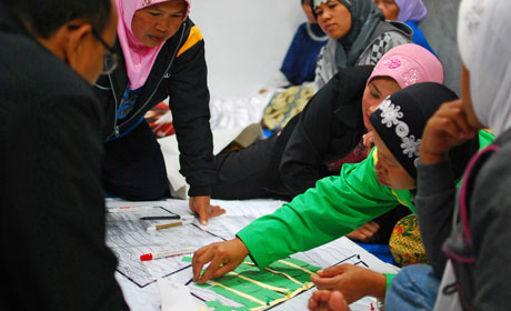 A group in Indonesia are discussing ideas at a table