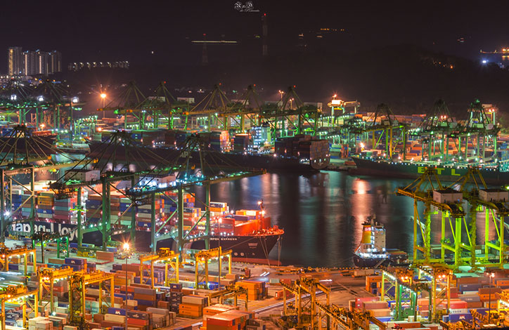 A brightly lit aerial view of a busy shipping port.
