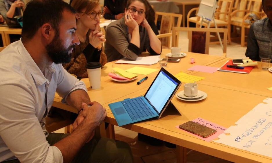 A group of young people discussing ideas at a table.
