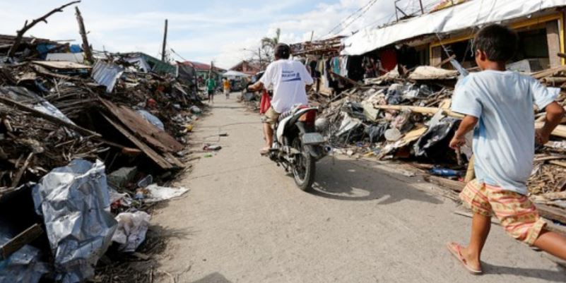 Two people among ruins after a disaster