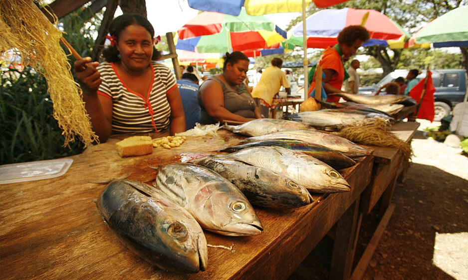 A woman selling fish at a market