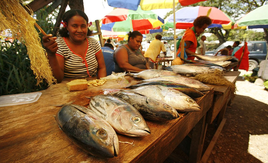 A woman selling fish at a market