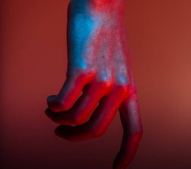 Hand in front of a red wall