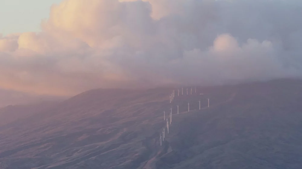 Wind farm on hillside over sea