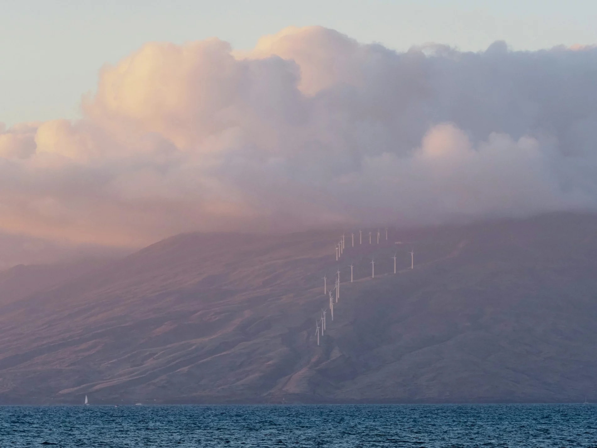 Wind farm on hillside over sea