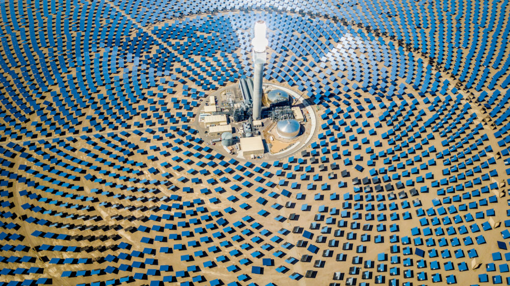 Drone aerial view of solar thermal power plant station in the desert.