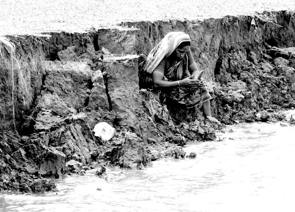 Photo of woman by eroded river bank in Bangladesh - Taneesha Mohan