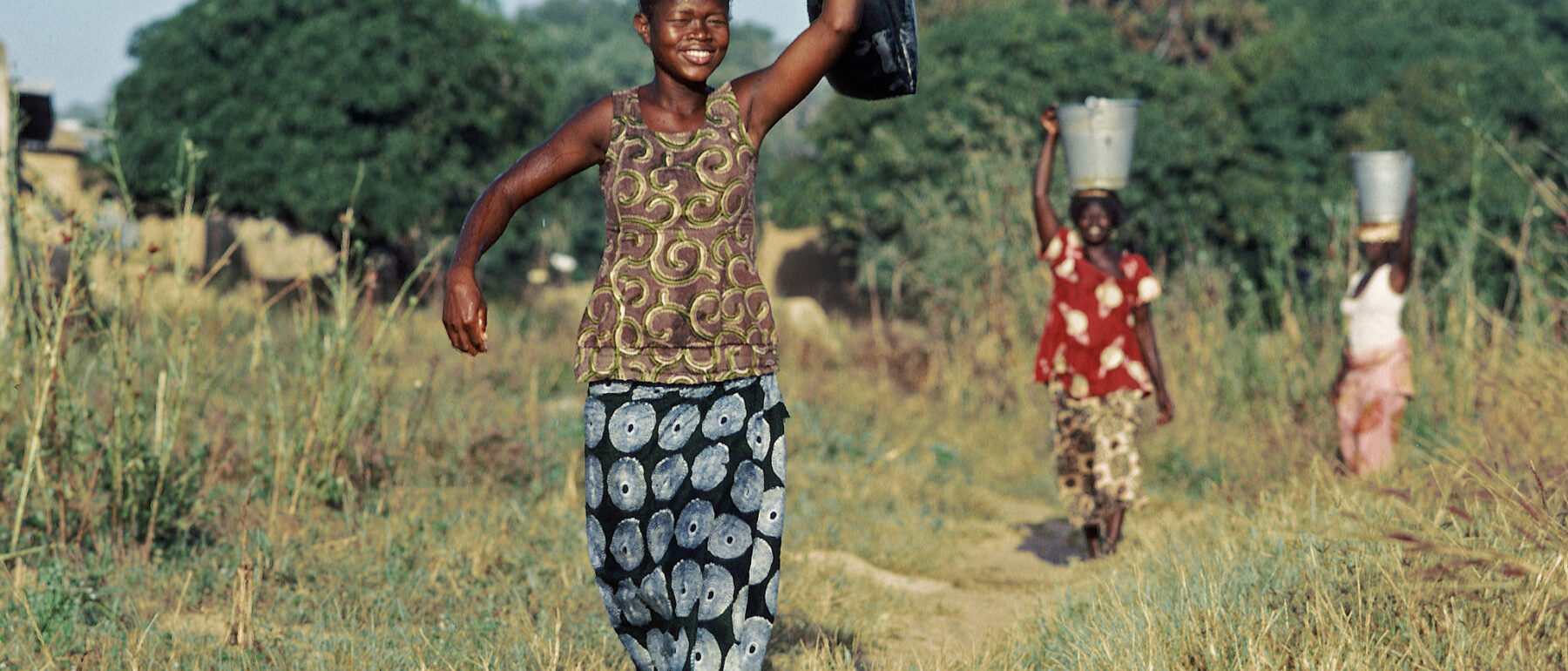 women walking through field