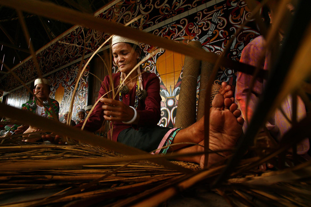 woman sitting weaving natural fibres