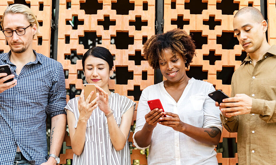 A group of people reading on their smartphones.