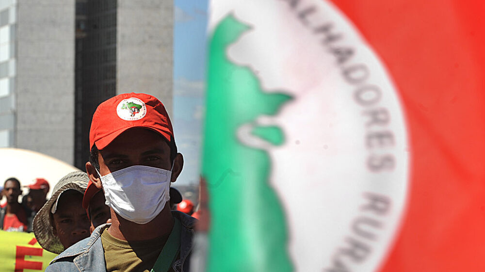 Photo - of a member of the Movement of Landless Rural Workers (MST), wearing a mask - Marcello Casal JR/ABr on Wikimedia CC3.