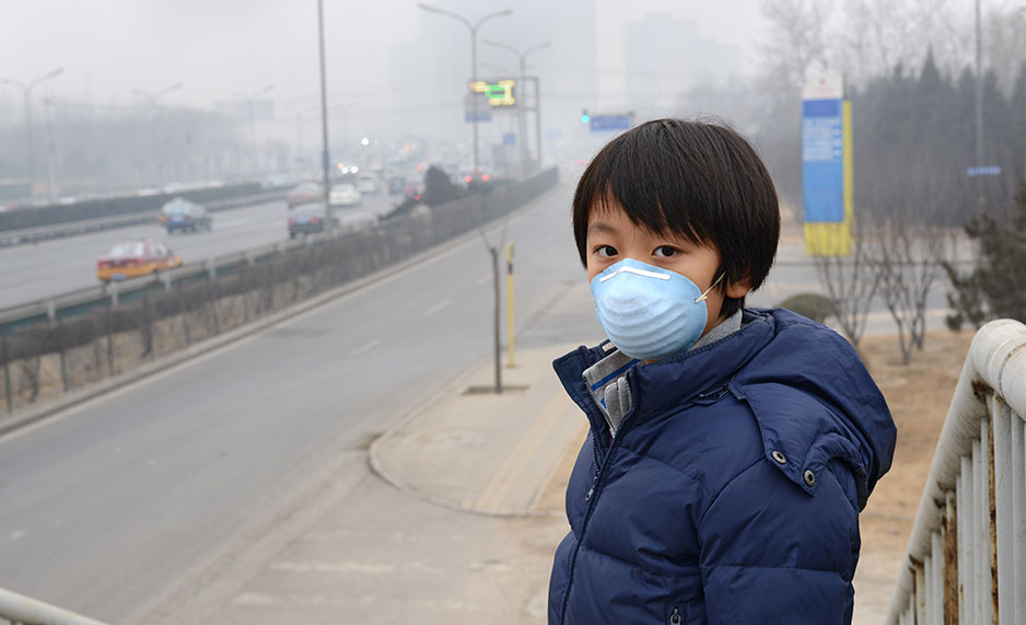 Boy wearing a mouth mask against air pollution (Beijing).