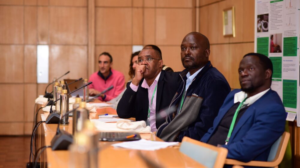 Conference participants listen to proceedings.