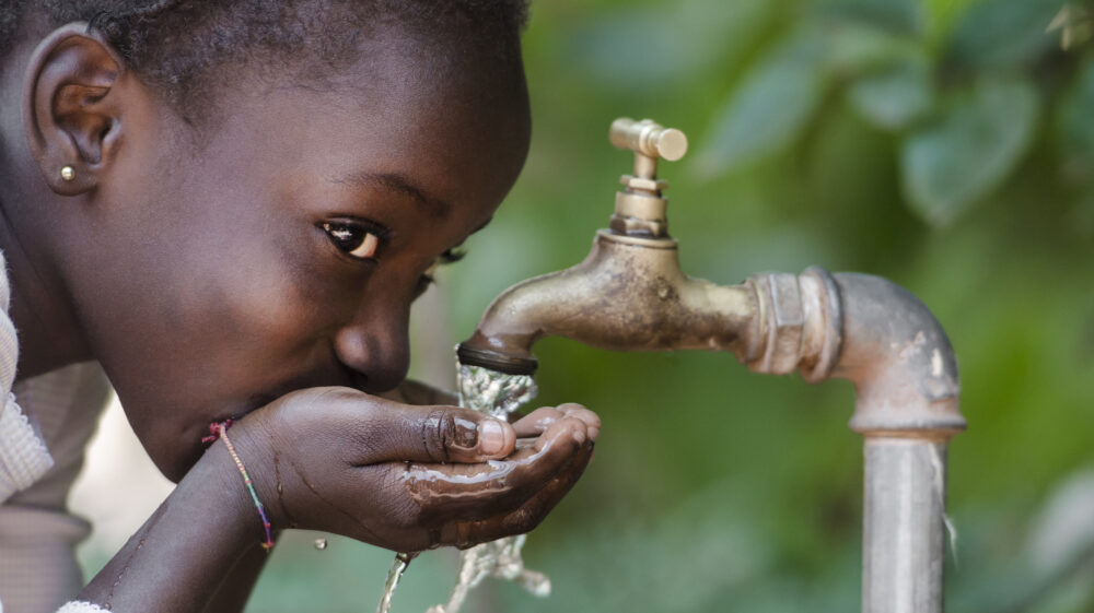 Child Drinking Fresh Water From Tap
