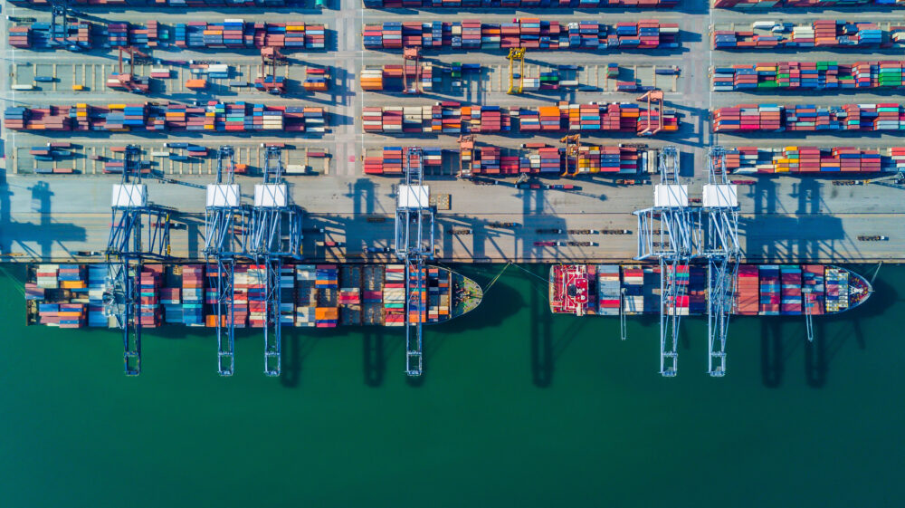 Containers being offloaded from ship in a port.