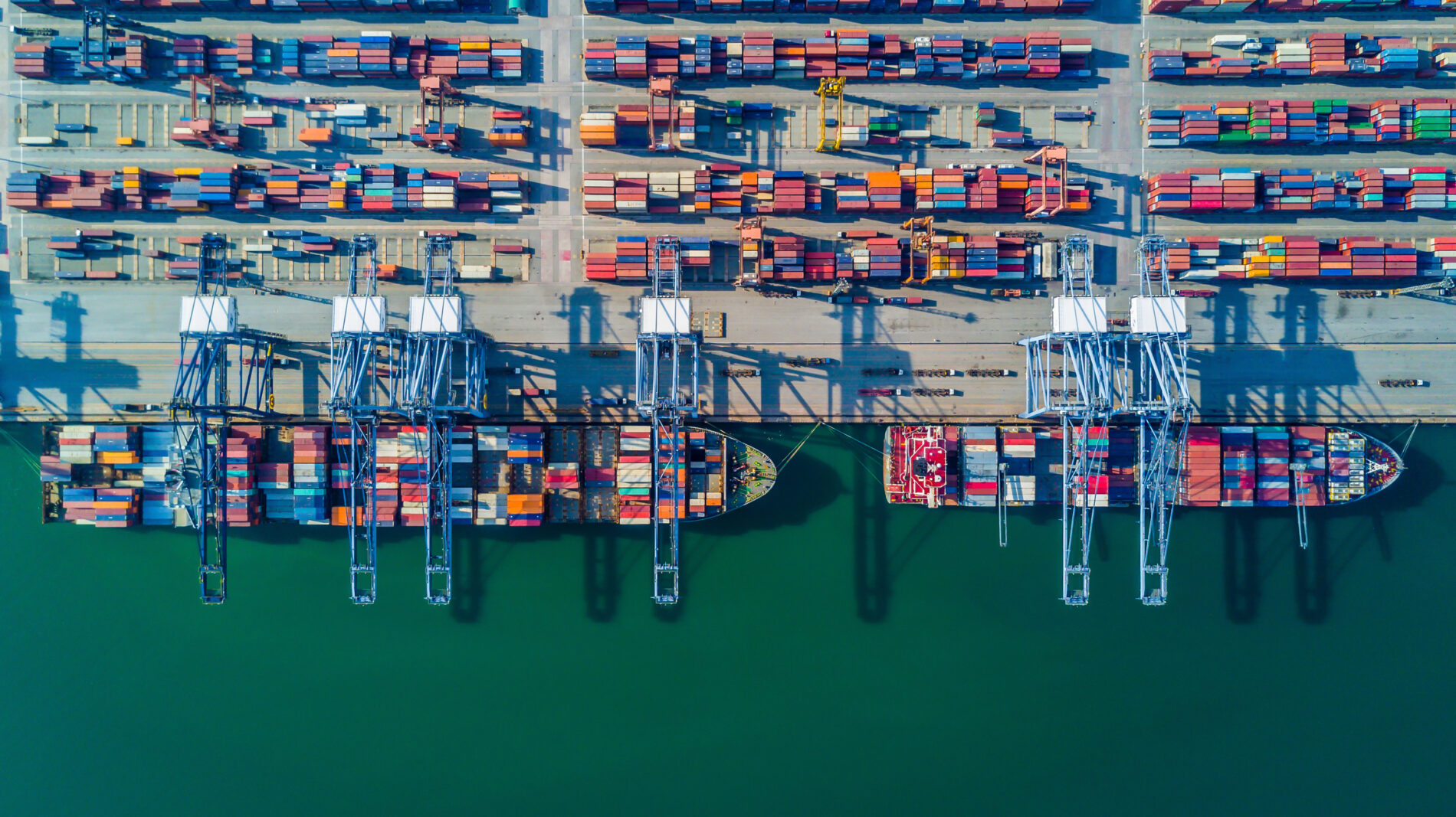 Containers being offloaded from ship in a port.