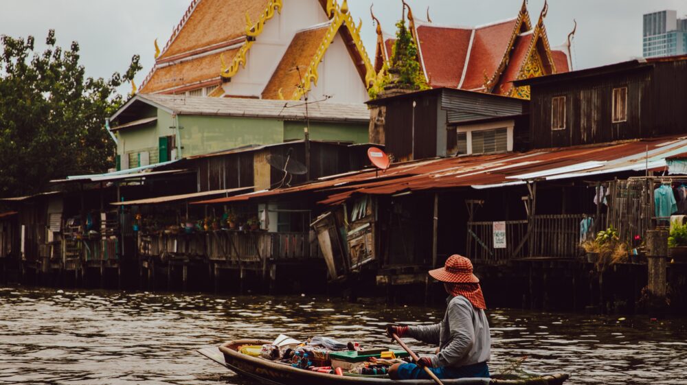 Woman steering a boat on one of Bangkok's canals.