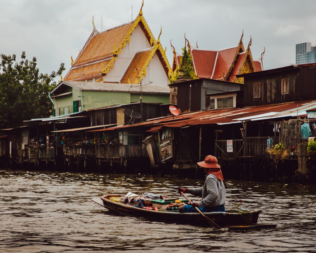 Woman steering a boat on one of Bangkok's canals.