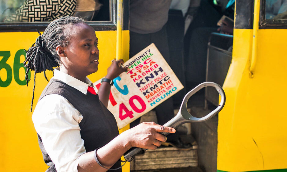 A woman working with public transport in East Africa.