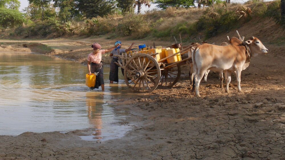 Woman drawing water in Central Myanmar
